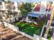 Aerial view of backyard featuring artificial lawn, manicured plantings, and a small seating area on a patio at 2537 N Miller Rd, Scottsdale, AZ 85257