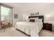 Bright bedroom featuring neutral carpet, a bright window, and a comfortable bed with a gray headboard at 2537 N Miller Rd, Scottsdale, AZ 85257