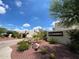 Welcoming entrance to El Cuadro community with lush desert landscaping and clear blue skies at 2537 N Miller Rd, Scottsdale, AZ 85257