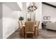 Bright dining room features a modern chandelier, dining table, and views into an adjacent living space at 2537 N Miller Rd, Scottsdale, AZ 85257