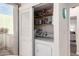 Laundry area with stacked washer and dryer and sliding doors at 2537 N Miller Rd, Scottsdale, AZ 85257