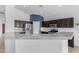 Beautiful kitchen featuring dark wood cabinets, stainless steel appliances, and a spacious marbled countertop at 2882 E Indian Wells Pl, Chandler, AZ 85249
