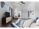 Relaxing bedroom with ceiling fan, hardwood floors, and ensuite bathroom at 2882 E Indian Wells Pl, Chandler, AZ 85249