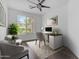 Bright and functional home office with a large window, modern desk, and comfortable seating at 2882 E Indian Wells Pl, Chandler, AZ 85249
