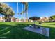 A shaded picnic table and barbeque grill offers a relaxing common area at 30 E Brown Rd # 2052, Mesa, AZ 85201