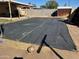 Large backyard area with a covered area along a block wall providing options for renovation at 3211 W Bethany Home Rd, Phoenix, AZ 85017