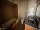 This bathroom includes a tiled shower-tub combination, toilet, and sink with vanity at 3211 W Bethany Home Rd, Phoenix, AZ 85017