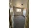 A small carpeted bedroom with a window at 3211 W Bethany Home Rd, Phoenix, AZ 85017