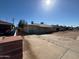 A street view featuring single story homes with long driveways on a sunny day at 3211 W Bethany Home Rd, Phoenix, AZ 85017