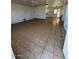 A very spacious living room with tile flooring and neutral walls needing some TLC at 3211 W Bethany Home Rd, Phoenix, AZ 85017