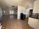 A view of the tile floored living room, open to the kitchen and the front door at 3211 W Bethany Home Rd, Phoenix, AZ 85017