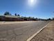 A sunny street view reveals a row of modest single-Gathering homes under a clear blue sky at 3211 W Bethany Home Rd, Phoenix, AZ 85017