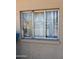 Damaged window with broken panes needing repair, suitable for customization at 3211 W Bethany Home Rd, Phoenix, AZ 85017