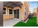 Cozy back patio featuring a pergola, artificial turf, and sliding glass doors for indoor-outdoor living at 3507 E Erie St, Gilbert, AZ 85295