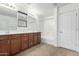 Bright bathroom featuring double sinks, a large mirror, and a shower-tub combo at 3507 E Erie St, Gilbert, AZ 85295