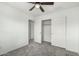 Bedroom boasting a ceiling fan, neutral carpet, and a well-organized closet at 3507 E Erie St, Gilbert, AZ 85295