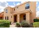 Two-story tan home with covered entry, landscaping, and brick walkway at 3507 E Erie St, Gilbert, AZ 85295