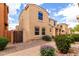 Light tan two-story home featuring landscaped yard, brick pathway, and a gate at 3507 E Erie St, Gilbert, AZ 85295