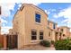 Two-story tan home with a landscaped front yard, gate and brick pathway at 3507 E Erie St, Gilbert, AZ 85295