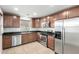 A kitchen featuring stainless steel appliances, wooden cabinets, and dark countertops at 3507 E Erie St, Gilbert, AZ 85295