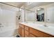 This bathroom showcases a double sink vanity and tub-shower combo with a large mirror at 3542 E Pala Ct, Gilbert, AZ 85297