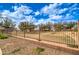 Community park with drought-tolerant landscape, grassy areas, and wrought-iron fence for added security at 3542 E Pala Ct, Gilbert, AZ 85297