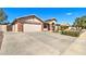 Spacious home with a wide driveway, two-car garage, and desert landscaping for easy maintenance at 3542 E Pala Ct, Gilbert, AZ 85297