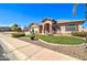 Inviting single-Gathering home featuring lush landscaping, a manicured lawn, and a welcoming entrance at 3542 E Pala Ct, Gilbert, AZ 85297