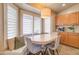 A kitchen nook with bench seating surrounded by a large bay window with white wood shutters at 3542 E Pala Ct, Gilbert, AZ 85297