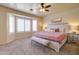 A well-lit main bedroom with neutral tones and a bay window with bright light-filtering shutters at 3542 E Pala Ct, Gilbert, AZ 85297