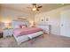 Neutral main bedroom boasts a ceiling fan, and includes matching nightstands and an upholstered bench at 3542 E Pala Ct, Gilbert, AZ 85297