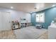 Large playroom with blue accent wall, white shelving units and a table with chairs at 3542 E Pala Ct, Gilbert, AZ 85297