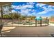 Beautiful backyard pool with rock waterfall feature and safety fence at 3542 E Pala Ct, Gilbert, AZ 85297