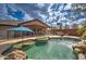 Inviting pool with rock accents, surrounded by a lush backyard oasis at 3542 E Pala Ct, Gilbert, AZ 85297