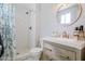 Modern bathroom showcasing a vanity with stone countertop and a subway tile shower at 3619 E Friess Dr, Phoenix, AZ 85032