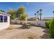 Charming backyard patio featuring a brick paver area with an outdoor dining set, gravel and a white block wall at 3619 E Friess Dr, Phoenix, AZ 85032