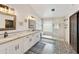 Elegant bathroom featuring dual sinks, granite counters, modern fixtures, and a glass block window over a stunning walk-in shower at 493 E Baylor Ln, Gilbert, AZ 85296