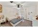 Charming bedroom with two twin beds, decorative pillows, rainbow decals, and a ceiling fan providing a cheerful and cozy space at 493 E Baylor Ln, Gilbert, AZ 85296