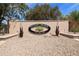 Settler's Meadow community sign with a green tree logo and decorative metal accents at 493 E Baylor Ln, Gilbert, AZ 85296