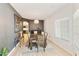 Dining room features modern chandelier, neutral tones, and wood table at 493 E Baylor Ln, Gilbert, AZ 85296