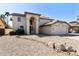 Two-story home with desert landscaping, light stucco, and an arched entryway at 493 E Baylor Ln, Gilbert, AZ 85296