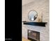 Contemporary fireplace with stone surround, mantle and decorative mirror at 493 E Baylor Ln, Gilbert, AZ 85296