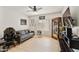 Inviting living room with sleek gray sofa, decorative cabinet, ceiling fan, and laminate flooring, perfect for relaxing or entertaining at 493 E Baylor Ln, Gilbert, AZ 85296