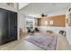 Bright entry foyer with a large patterned rug, modern furniture, and natural light at 493 E Baylor Ln, Gilbert, AZ 85296