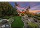 An expansive backyard featuring lush landscaping and scenic mountain views at 5254 E Arroyo Rd, Paradise Valley, AZ 85253