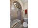 Tiled shower with glass door next to the toilet and towel rack at 5254 E Arroyo Rd, Paradise Valley, AZ 85253