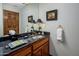 Charming powder room boasts patterned wallpaper, black marble countertops, and classic fixtures at 5254 E Arroyo Rd, Paradise Valley, AZ 85253