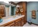 Traditional bathroom with a white countertop, wooden cabinets, and a shower/tub combo at 5254 E Arroyo Rd, Paradise Valley, AZ 85253