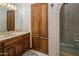 Bathroom with tiled shower, wood cabinets, and a built-in storage cabinet at 5254 E Arroyo Rd, Paradise Valley, AZ 85253