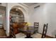 Dining area with a dark wood table, seating for four, and a mirrored beverage station at 5254 E Arroyo Rd, Paradise Valley, AZ 85253